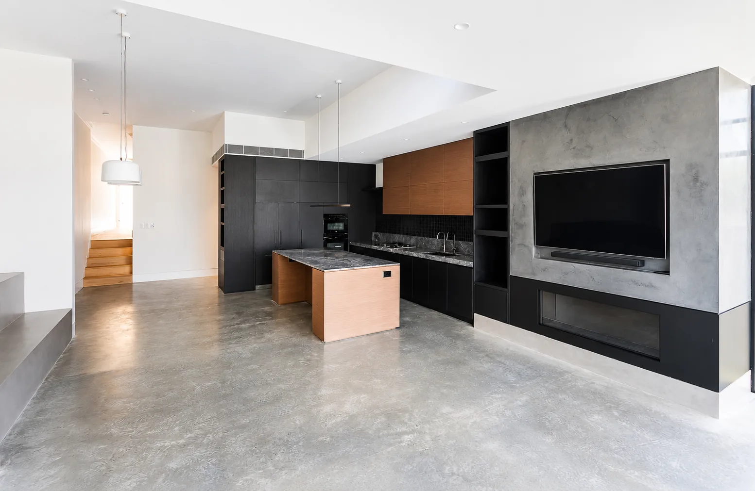 Parkview Road Fairlight — open living with polished concrete floor and black-oak kitchen