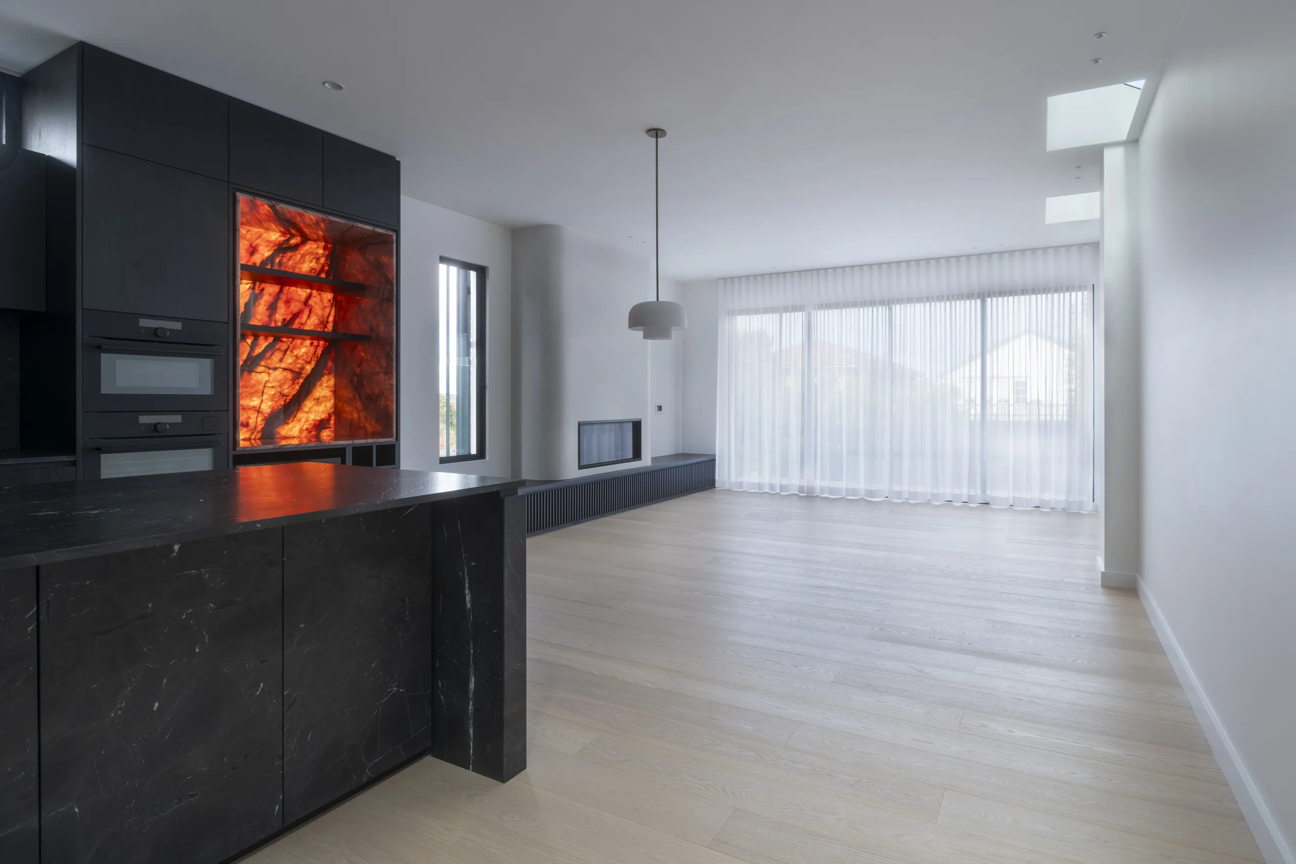 59 Fairlight Street — open-plan living with black marble kitchen and backlit onyx feature